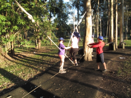 Students doing rope balancing activities at camp
